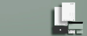 Moderne Geschäftspapiere auf einem sanften, einfarbigen Hintergrund, bestehend aus Briefpapier, Umschlägen und Visitenkarten mit minimalistischen Designs und dem Logo von CONSENS.